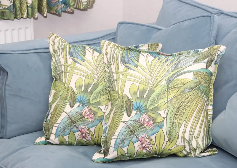 Handmade tropical print cushions on a blue sofa by Heather Horrocks Leigh